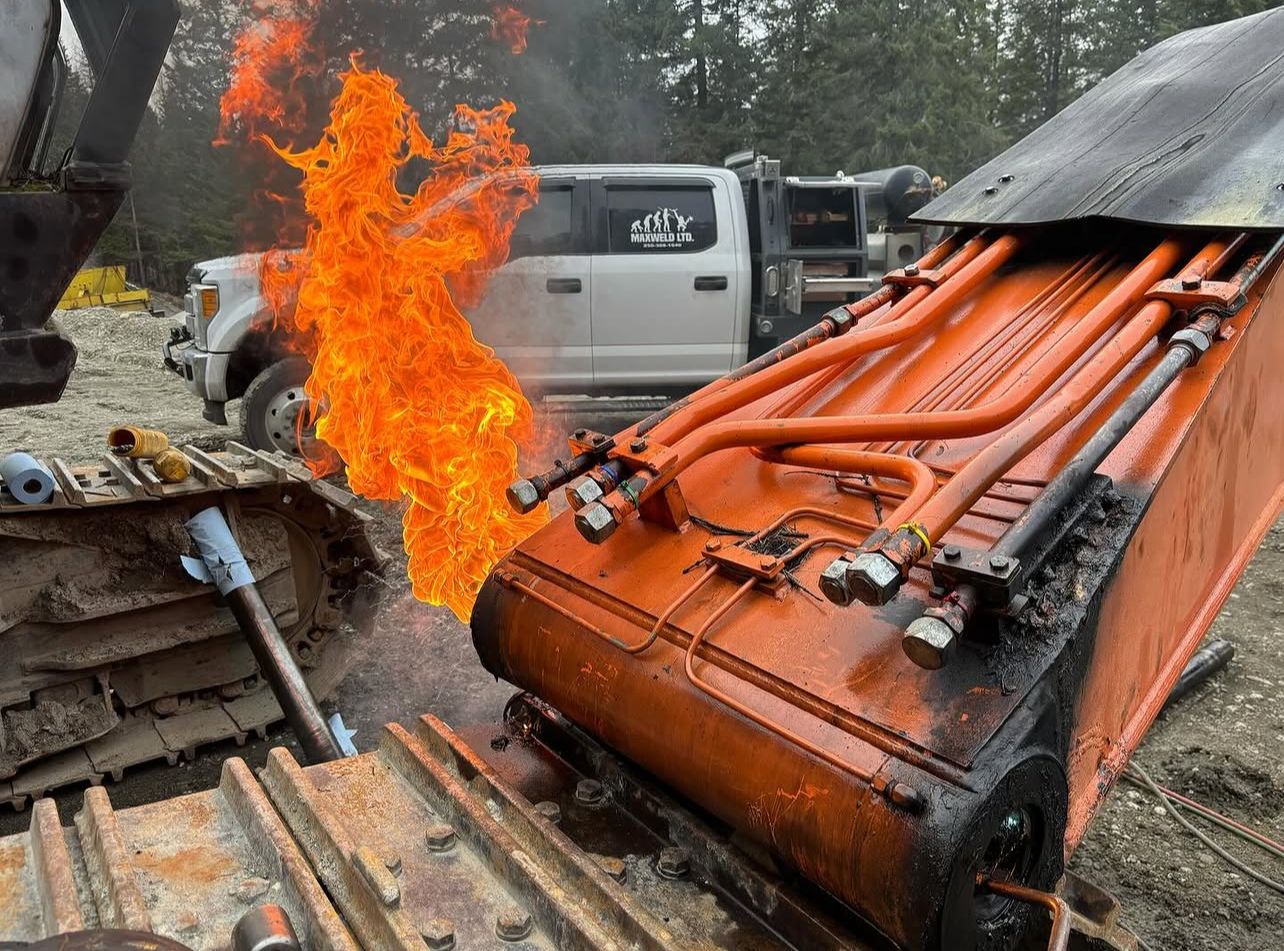 Maxweld Ltd. service truck on-site with heavy equipment and flames